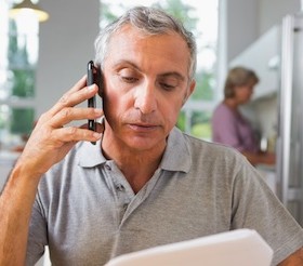 man making insurance claim over phone